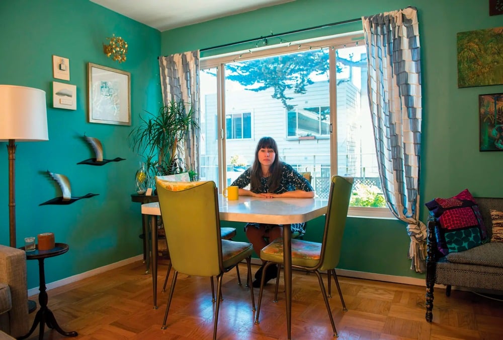 a woman sitting at a small table