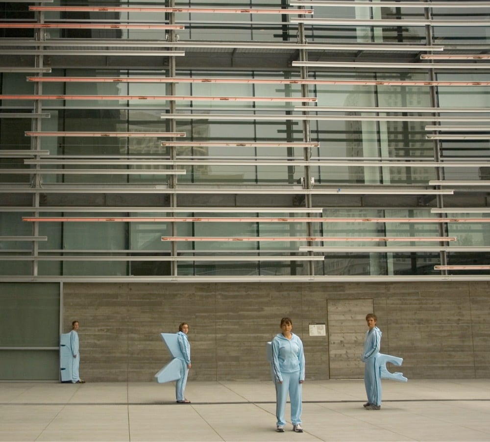 four people dressed in blue track suits