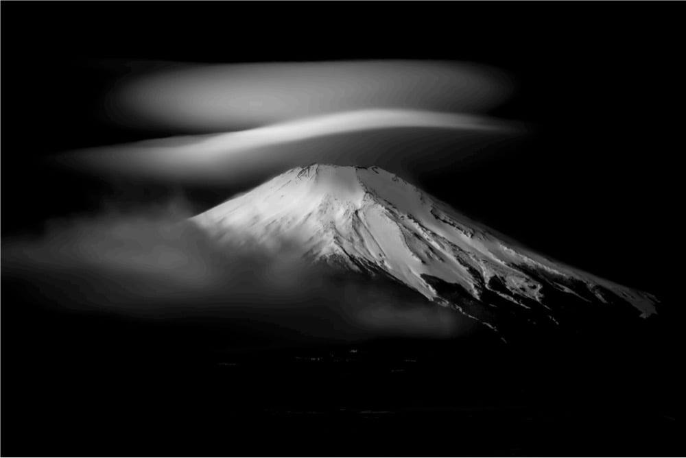 a snow-covered mountain in the fog