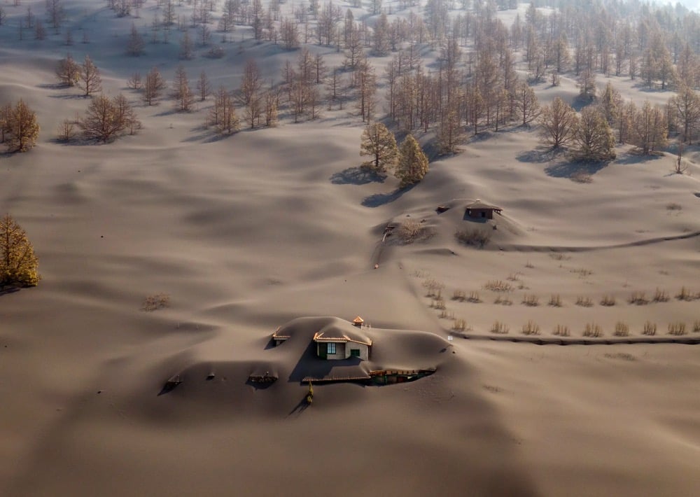 volcanic ash almost completely covers a house