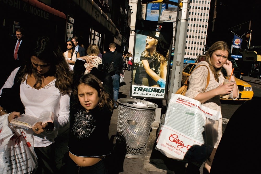 a number of people walking on the street in NYC