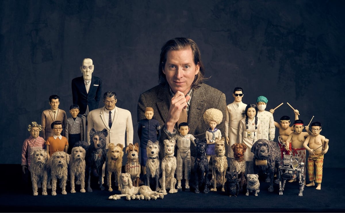 Wes Anderson pictured with a number of the models from Isle of Dogs