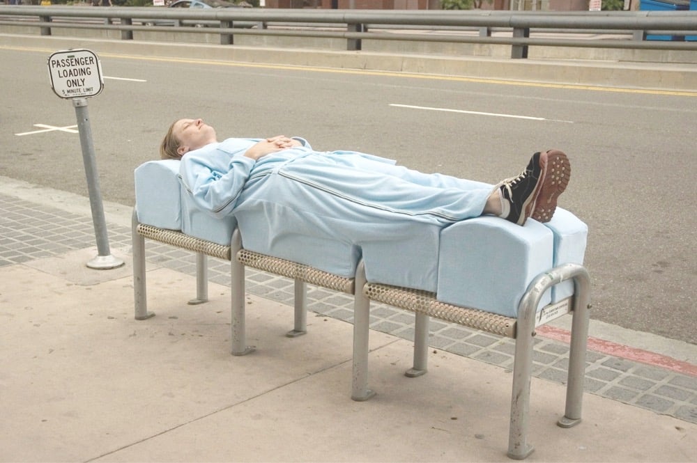 a woman lying on a bench