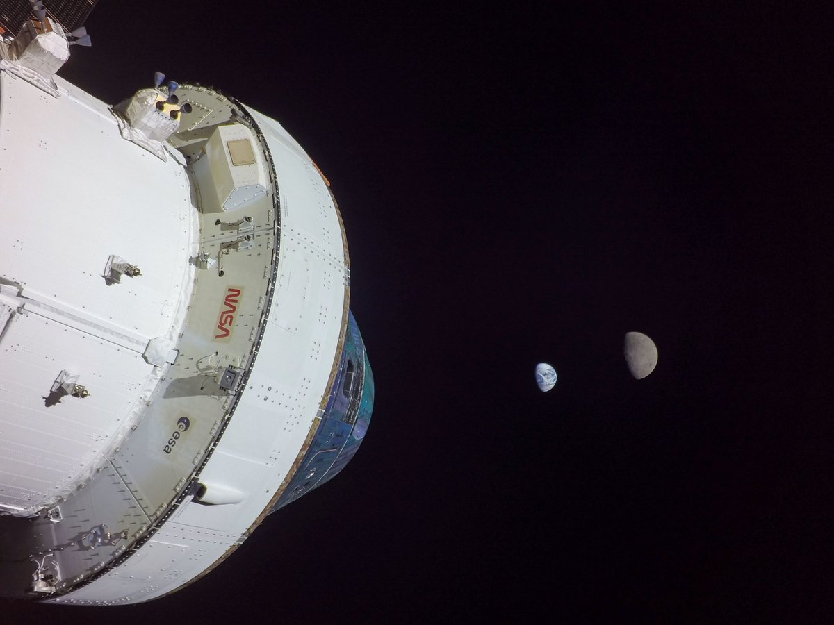 photo of the Moon and Earth with the Artemis I spacecraft in the foreground