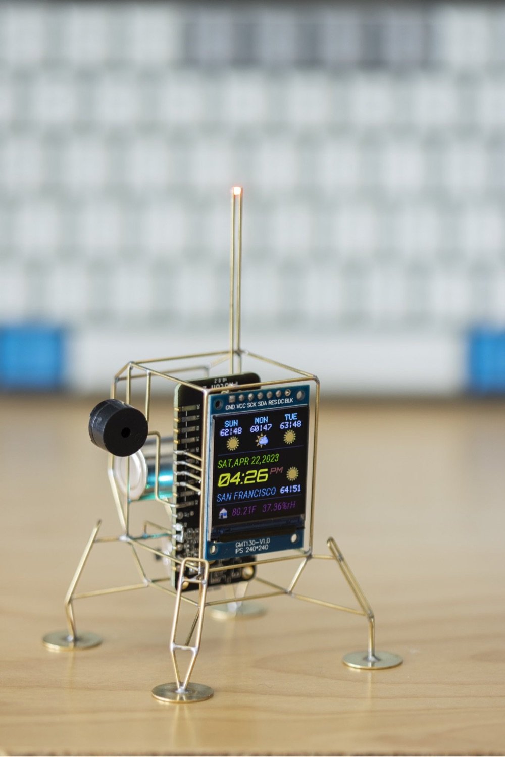 a little desktop sculpture that displays the weather on a color display