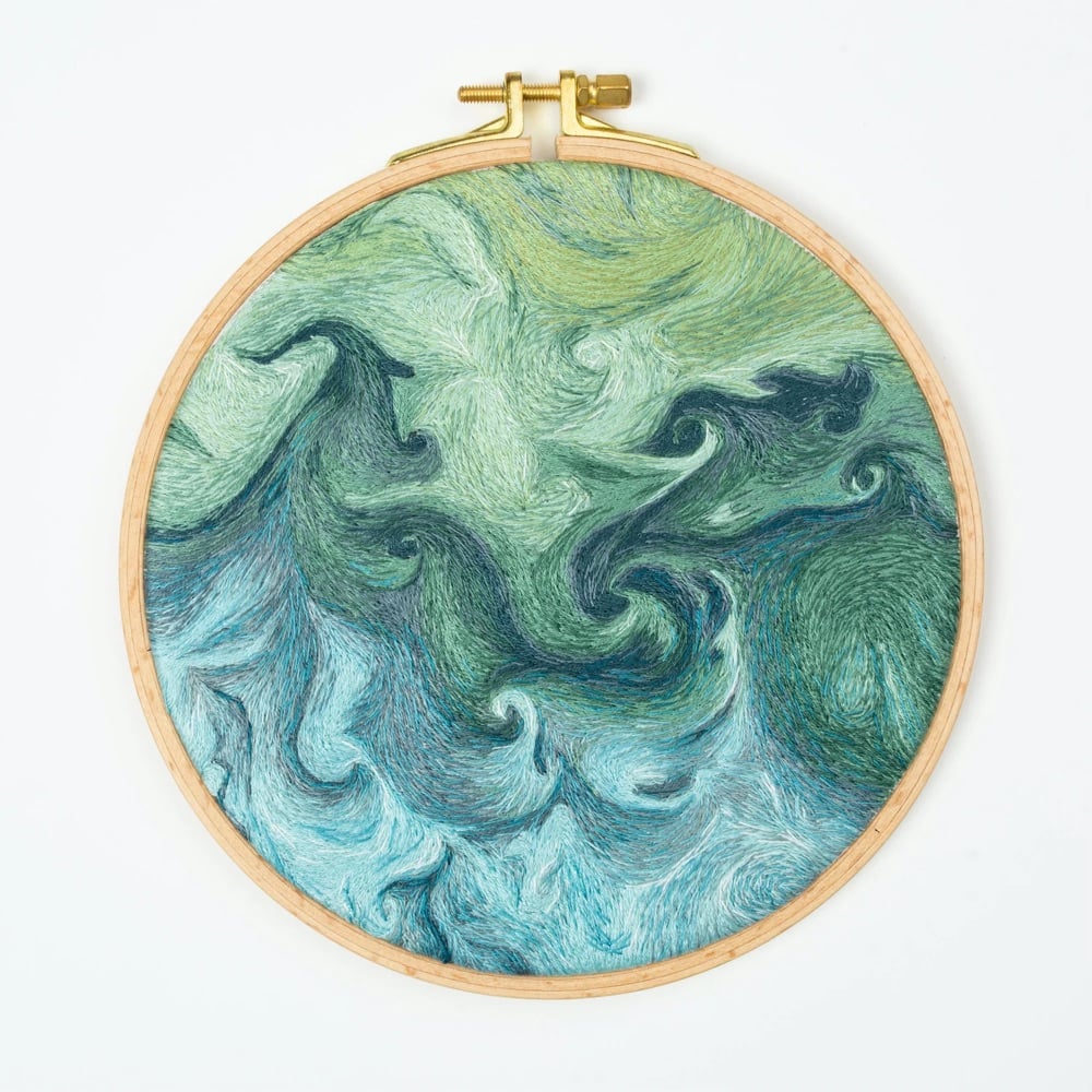 hand-embroidered artwork of a satellite view of Earth