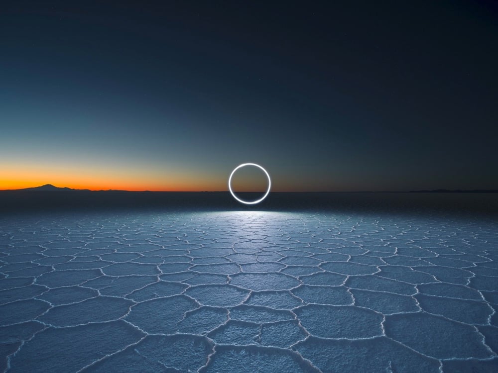 a circle of light over a salt flat