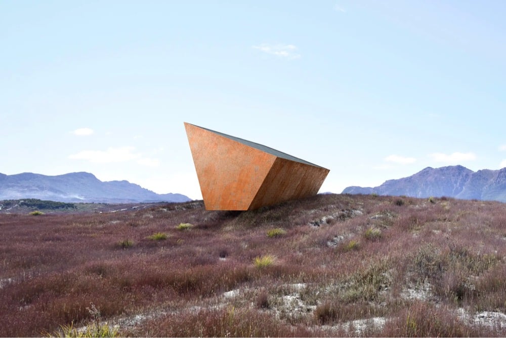 an oddly shaped building on a grassy hill in Tasmania