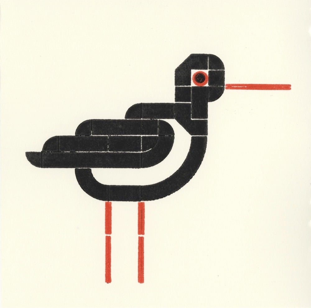 letterpress print of a bird printed using Lego bricks