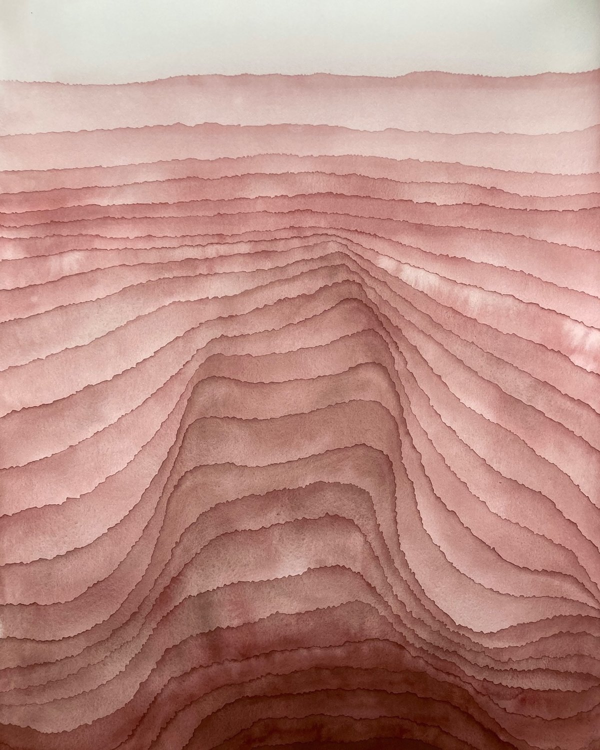 wavy pink layers that look like sedimentary rocks