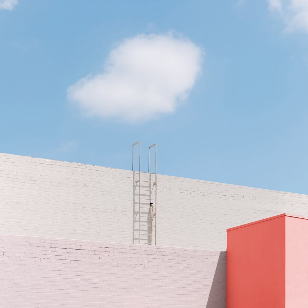 a red and gray building with a cloud