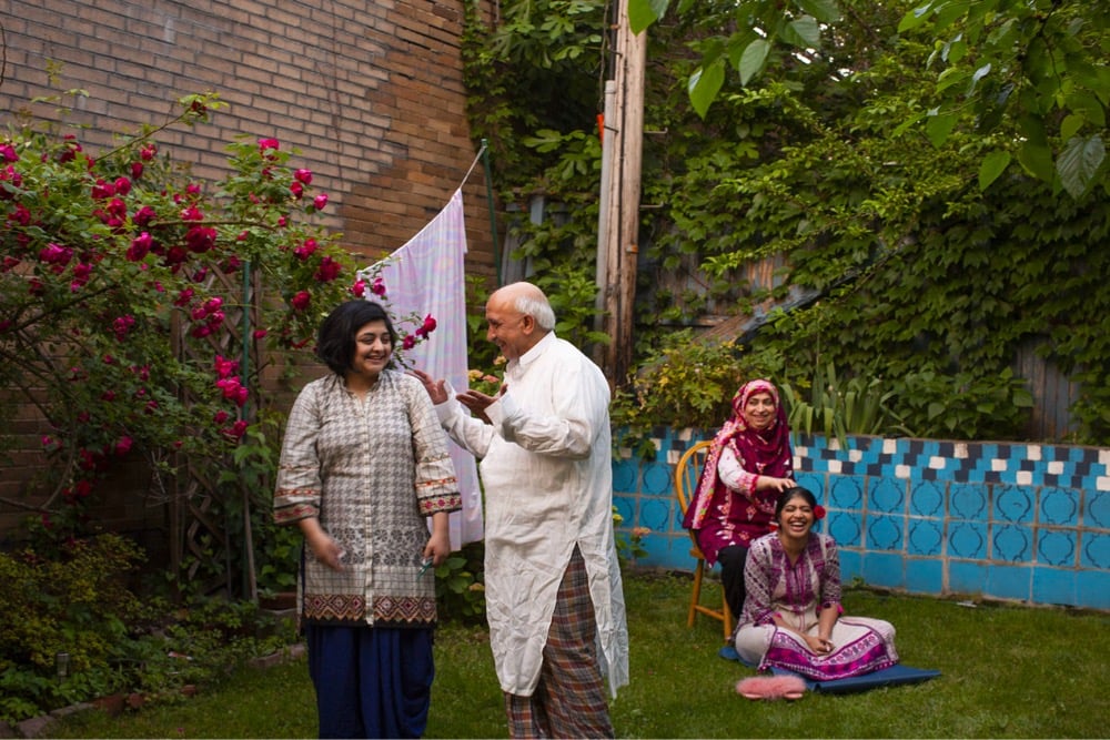 a family laughs together in a yard